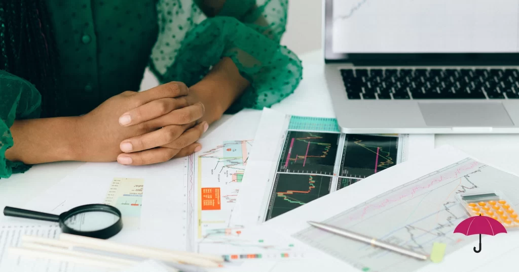 a woman with her hands folded as she examines data from a website audit