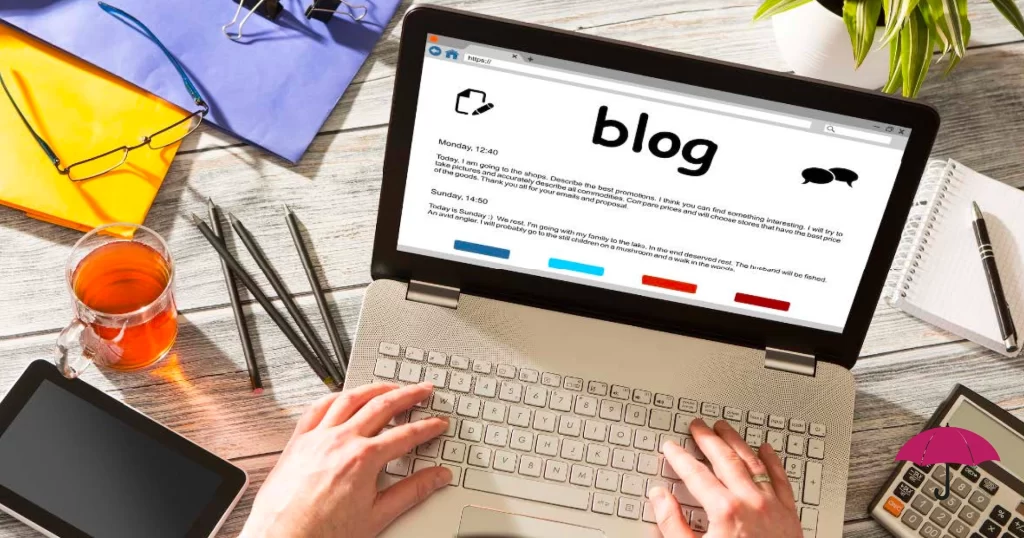 picture of someone working at a desk on a laptop, writing a blog